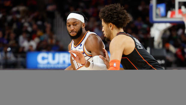 Phoenix Suns forward Josh Okogie (2) dribbles defended by Detroit Pistons guard Cade Cunningham (2) in the first half at Little Caesars Arena.